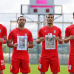 Football: Iranian players take to the pitch against Costa Rica with photos of children killed by bombs